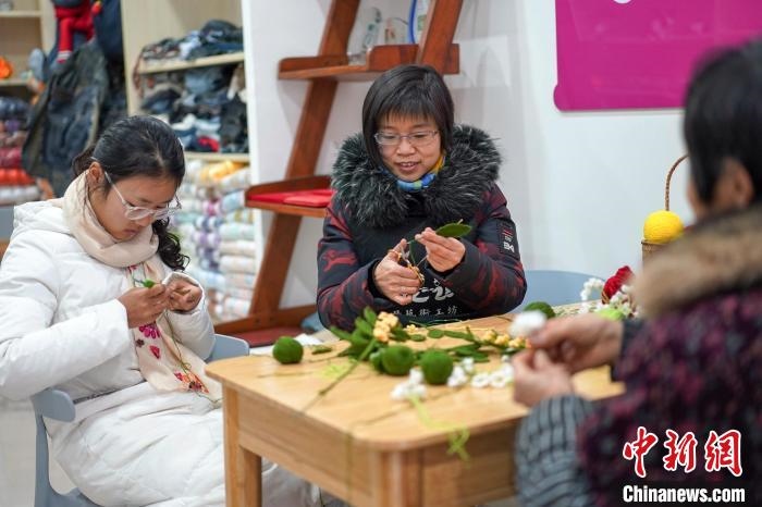 文創(chuàng)工作室的姐妹們正在鉤織月桂葉片。　古良駒 攝