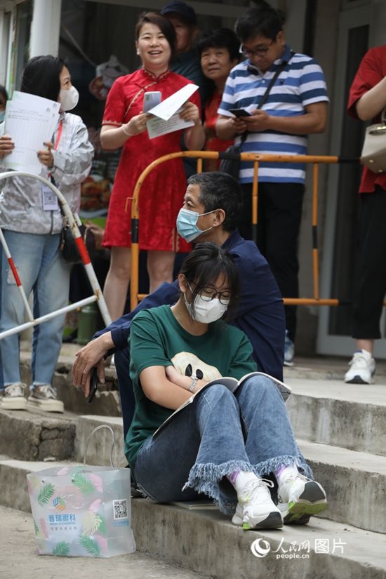 6月7日，沈陽市第一中學(xué)，學(xué)子靠在父親身邊做最后的沖刺。人民網(wǎng) 周頌雪攝