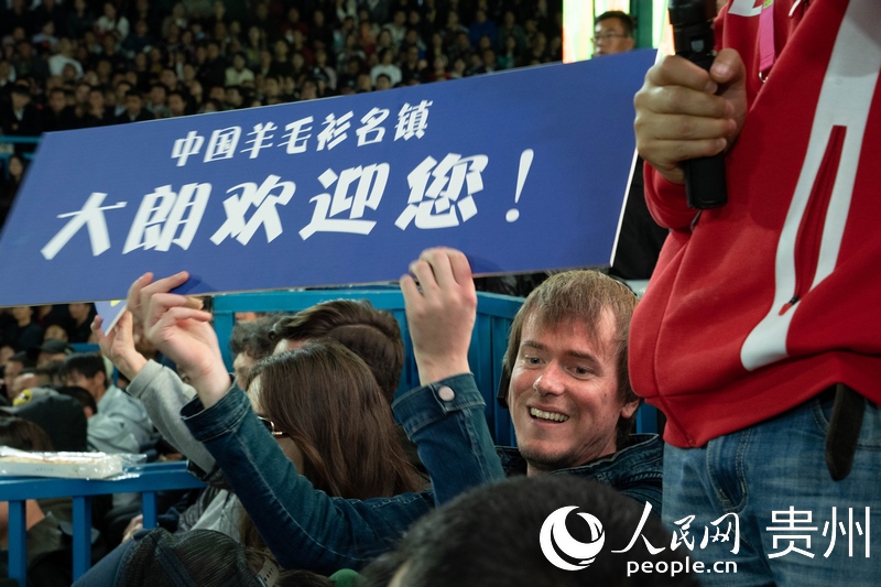 外媒記者舉起手牌為運(yùn)動(dòng)員加油。人民網(wǎng) 陽茜攝