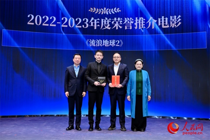 著名電影藝術(shù)家、事業(yè)家王曉棠（右一）和中國文聯(lián)書記處書記張宏（左一）為《流浪地球2》出品人、總監(jiān)制、總制片人傅若清（右二）與導(dǎo)演郭帆（左二）頒發(fā)“2022-2023年度榮譽(yù)推介電影”