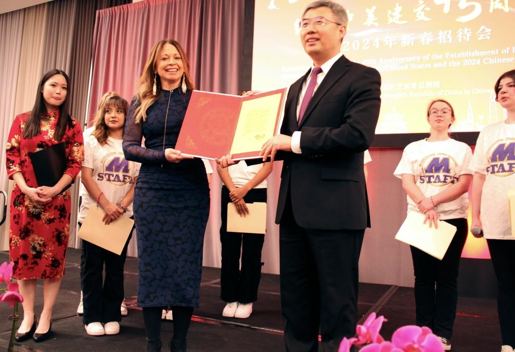 2024年2月27日，中國駐芝加哥總領(lǐng)事館舉辦慶祝中美建交45周年招待會，來自馬斯卡廷中學(xué)的學(xué)生們在招待會上收到一份特殊禮物——中國國家主席習(xí)近平給他們的復(fù)信。新華社記者 徐靜 攝