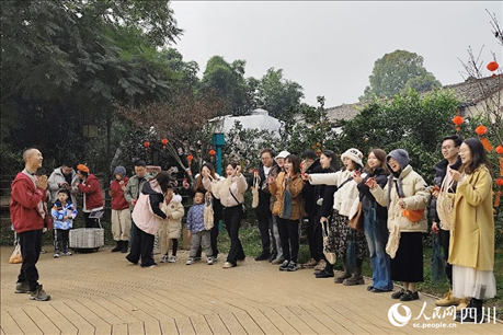 葉科（左一）給前來參與活動的“柑爸柑媽”介紹生態(tài)種植果。人民網(wǎng)記者朱虹攝