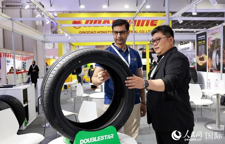 工作人員向客戶展示雙星電動汽車輪胎。和傳統(tǒng)汽車輪胎相比，電動汽車輪胎具有更高承載能力、更加靜音舒適、更好極速抓地、更低滾動阻力等特點。人民網(wǎng)記者 管克江攝